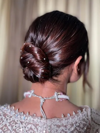 A close up of the sleek bun, showing the intricate twist and the placement of the crystals. It’s all about the small details that make a hairstyle special.