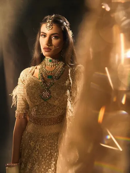 An artistic shot of a bridal look, playing with light and shadow. Understanding how light interacts with makeup is a key lesson in my masterclass, helping you create looks that are truly photogenic.