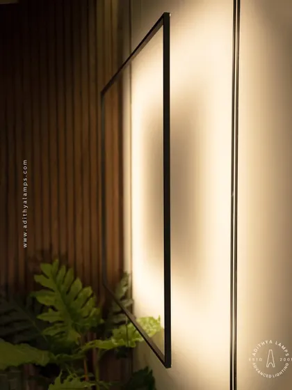 This unique floor-to-ceiling fixture features a large, suspended square frame that washes the wall with a soft, ambient light. It acts as both a light source and a bold, graphic art piece for a contemporary living room.