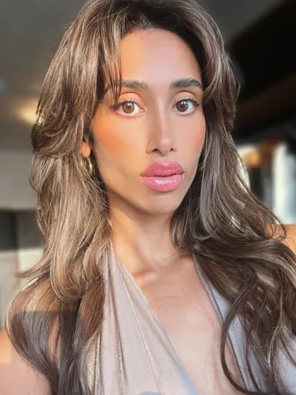 A stunning selfie from a happy client, showing off her new layered and highlighted extensions. This is what confidence looks like.