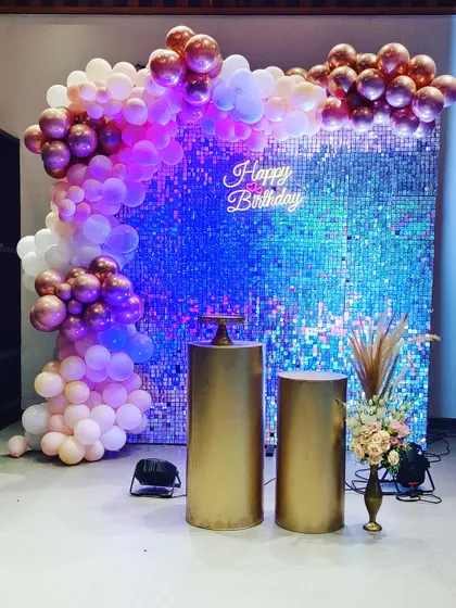 A simple yet glamorous setup perfect for adult birthdays or chic celebrations. This features a shimmering sequin wall that catches the light beautifully, paired with a custom 'Happy Birthday' neon sign and an organic balloon arch.