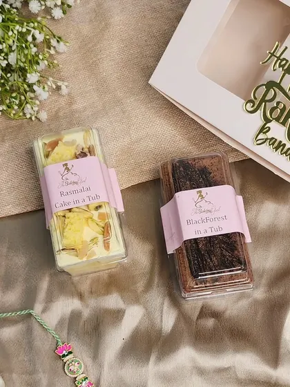 A unique fusion dessert for your sibling. This hamper includes two of my signature dessert tubs: a rich Black Forest cake and a creamy, Indian-inspired Rasmalai Cake.