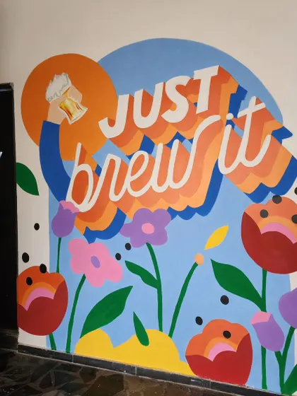 The "Just Brew It" mural at Cirkus, a playful and colorful piece with retro typography that celebrates their identity as a brewery.