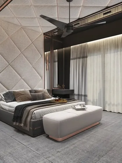 This bedroom features a dramatic, quilted fabric headboard wall and a four-poster bed frame in a contemporary style.