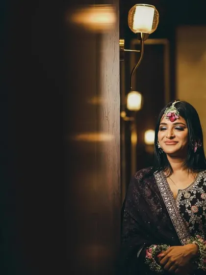 A serene portrait of the bride, her eyes closed in a moment of quiet contemplation. The warm, soft lighting creates an intimate and peaceful mood.