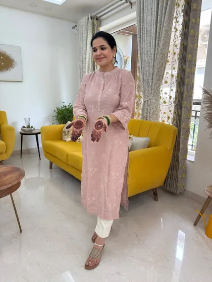 Another look at my simple and comfortable Hariyali Teej outfit. The pink kurta paired with white pants is a classic combination that's perfect for daytime celebrations. The yellow sofa adds a nice pop of color too!
