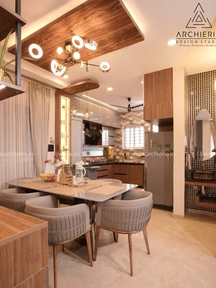 This dining room is connected to the kitchen and features a wooden false ceiling that adds warmth and character. The design is both beautiful and practical for everyday living.
