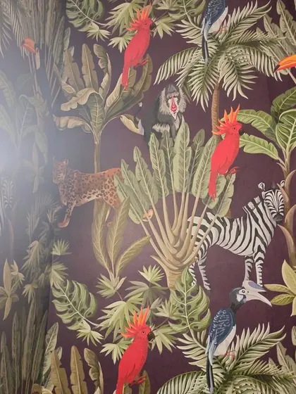 A wider view of the dark jungle wallpaper installation.