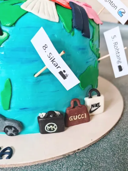 This side of the globe cake features even more miniature designer shopping bags from brands like Michael Kors, Gucci, and Nike.