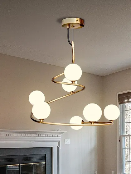 The spiral globe chandelier is also a great fit for spaces with a fireplace, adding to the warm and cozy ambiance.