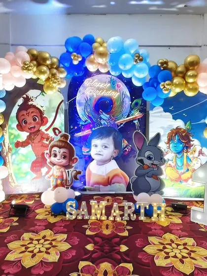 A divine Little Krishna theme for a first birthday. This setup includes cute cartoon Krishna cutouts, a blue and gold balloon arch, and a personalized backdrop, perfect for a blessed celebration.