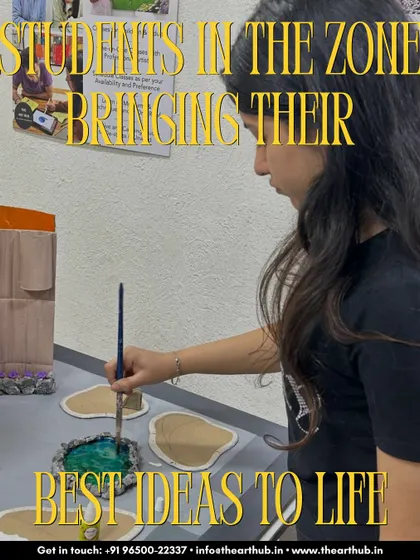 A student in the zone, bringing her best ideas to life. Here, she is painting a detailed architectural model, a key component of a strong design portfolio.