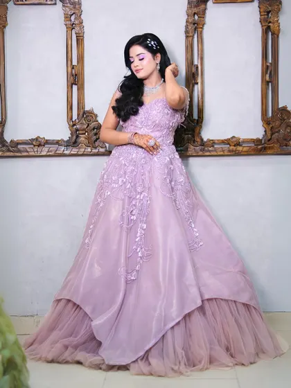 A full view of our lavender princess gown with delicate floral embroidery and an asymmetric layered skirt.