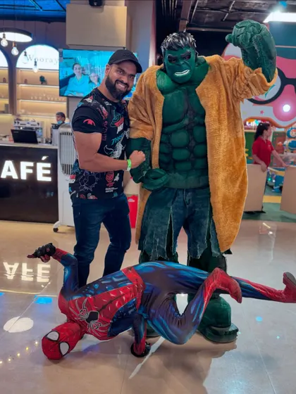 Even adults can't resist a photo with their favorite superheroes. Here, a guest poses with the Hulk and a flexible Spider-Man, showing that fun at Wooray Elite is for all ages.