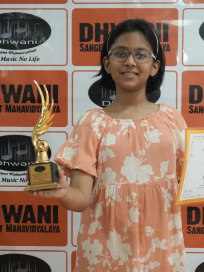 A happy student holds her trophy and certificate. Each award represents hours of practice, dedication, and passion for music.