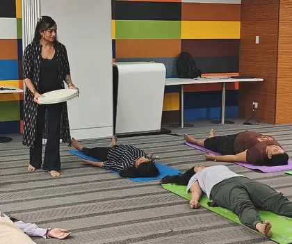 Participants in a corporate wellness session finding deep rest. It's powerful to witness professionals taking a moment for themselves to disconnect from work and reconnect with their inner peace.