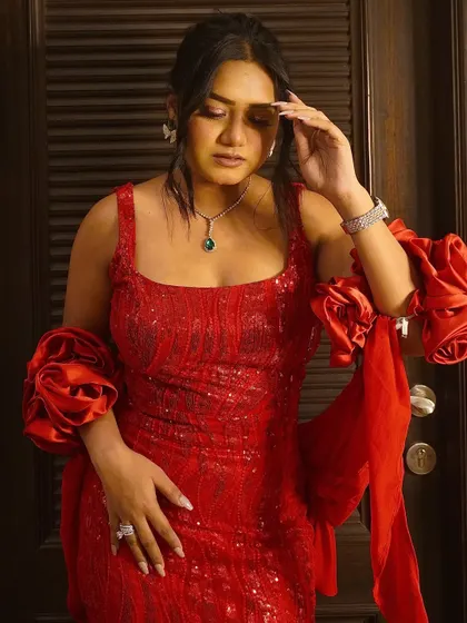 A dramatic pose in a stunning red sequin gown. Red is a power color that always makes a statement on stage.
