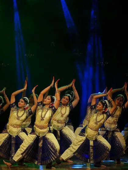 A graceful group pose from our 'Garuda Gamana' performance. The blend of blue and cream costumes, combined with the elegant arm movements, creates a sense of serenity and devotion.