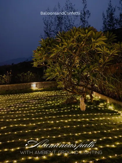 Creating a universe of light. This luminous path was created using hundreds of individual fairy lights laid across the lawn, guiding the couple to the main proposal spot.