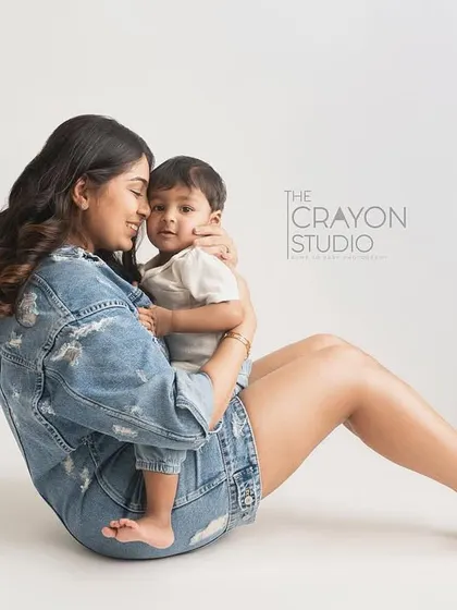 A tender moment between mother and son, captured in a clean and modern studio setting.