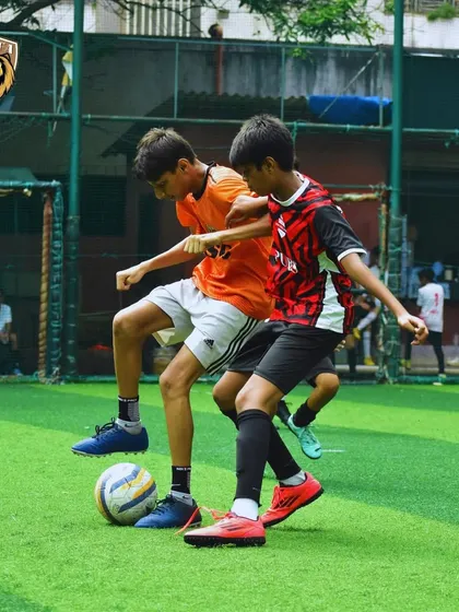 A physical battle for possession. We teach our players to be strong and fair in every challenge.