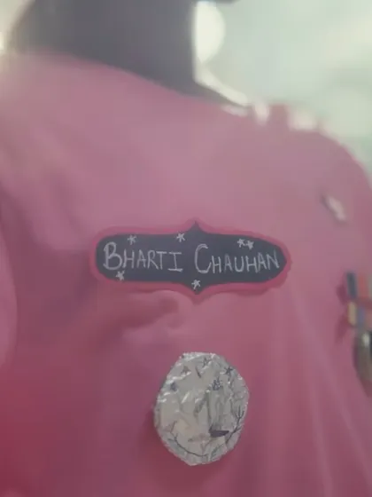 A detail shot of the DIY name tag and medals on the child's uniform. These small, handcrafted elements were essential for showing her creativity and the personal start of her dream to join the army.