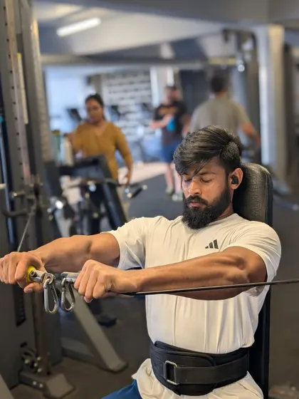 The peak contraction of a seated cable fly. This is where the real work happens, squeezing the muscle for definition.