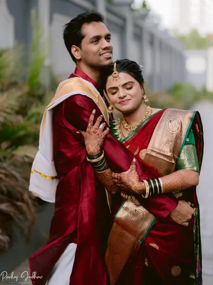 A tender embrace, showcasing the bride's intricate mehendi and traditional bangles.