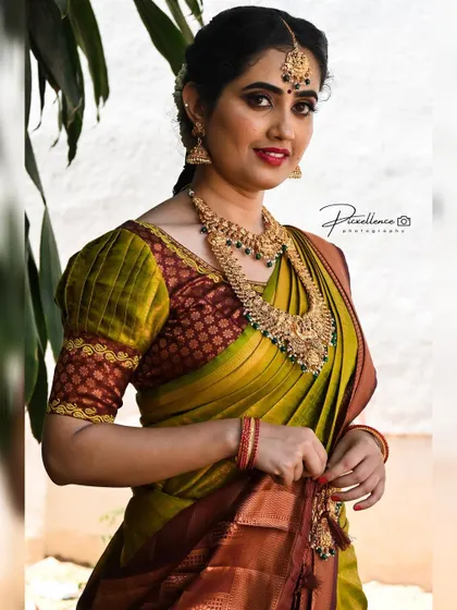 A classic red lipstick can truly complete a traditional bridal look. Here, it perfectly complements her beautiful green and maroon Kanjeevaram saree and gold jewellery.