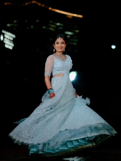 A full-length shot of the bride twirling in her reception lehenga. This captures the movement and detail of her outfit beautifully.