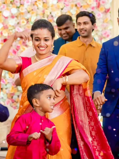 A mother dances with her son, both sharing a moment of pure happiness. These are the priceless memories that families will look back on for years to come.