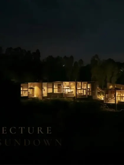 Glow mode: ON. This eco-resort, nestled in a forest, is lit thoughtfully after sundown, creating a warm and inviting presence that respects the natural surroundings.