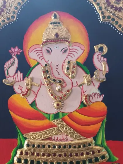 A close-up of a Tanjore painting of Lord Ganesha, created by my student Indu. Note the detailed gold foil work and stone embellishments that are characteristic of this style.