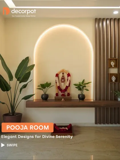 A minimalist and modern pooja space featuring a floating wooden shelf against an arched, backlit wall. The adjacent fluted panel adds texture and warmth to this serene corner.