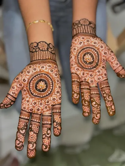 A beautiful, full-hand design for a bridesmaid, featuring a central lotus mandala surrounded by intricate floral patterns.