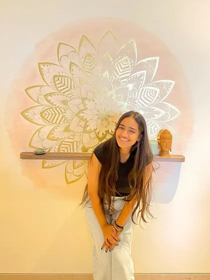 A happy photo with the finished gold leaf mandala. This piece adds a touch of shimmer and elegance to the room.