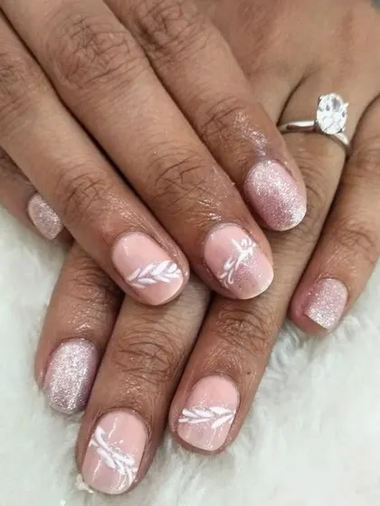 If you prefer not to get extensions, we can create beautiful art on your natural nails. Here, I did a pink glitter gel polish with delicate white leaf art.