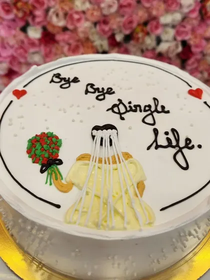 A clear shot of the "Bye Bye Single Life" cake, showing the simple but effective hand-piped design.