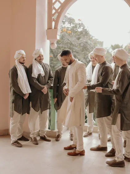 The groom, Avin, getting ready with his groomsmen. This candid shot captures the camaraderie and support of his closest friends and family.