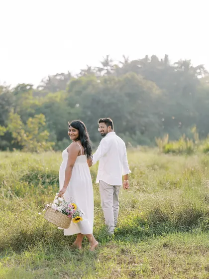 A playful "follow me" style shot as the couple walks through a field. It feels spontaneous and full of movement, telling the story of their journey together.
