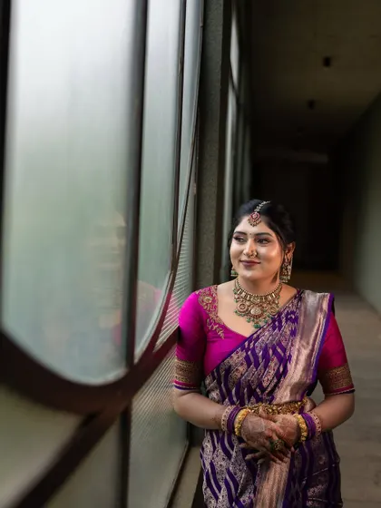 A quiet moment for the bride-to-be, captured by the window. The soft light and her thoughtful expression create a beautiful and serene portrait.