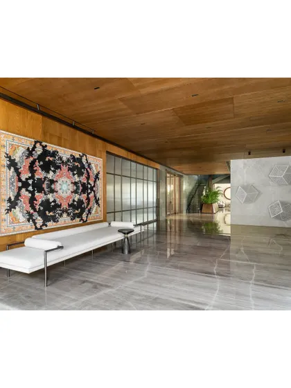 The far end of the K Residence lobby, where the staircase and service areas are located. Large sliding glass doors allow natural light to pour in from the living and dining rooms, maintaining a sense of openness.