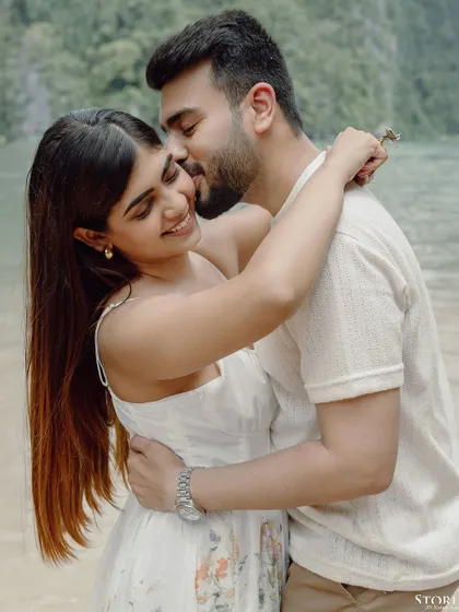 A tender and joyful close-up of the couple on a beach in Thailand, filled with genuine smiles and affection.