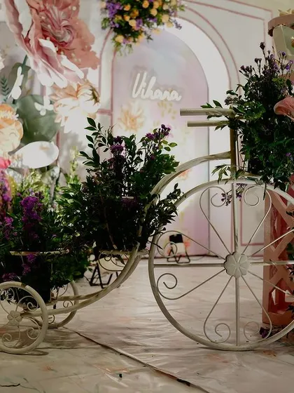 A vintage-style tricycle overflowing with flowers adds a touch of rustic charm to this fairytale garden party. I use a variety of props to add layers and texture to the overall event design.