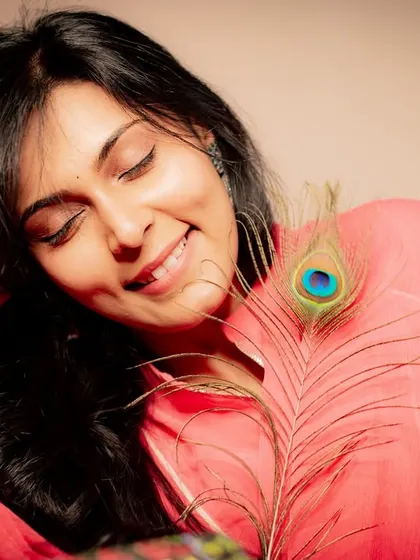 A peaceful smile with eyes closed. This serene portrait captures a moment of pure contentment.