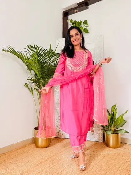 A bright pink suit set that is perfect for any celebration. The color is so joyful and the embroidery on the neck adds a touch of richness.