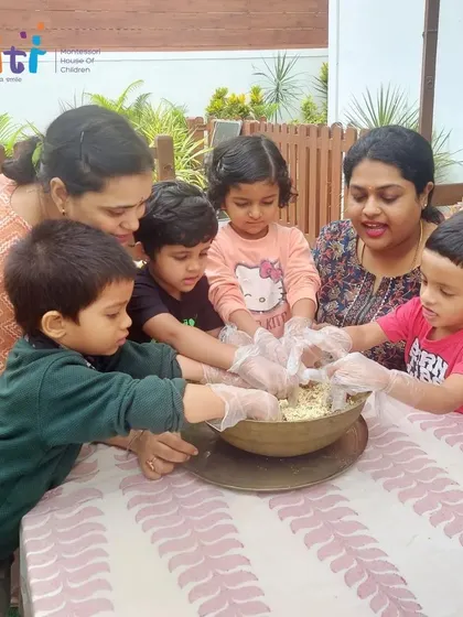 Children work together to mix ingredients for modaks, a traditional sweet for Ganesh Chaturthi. This collaborative cooking activity is a favorite during our festival celebrations.