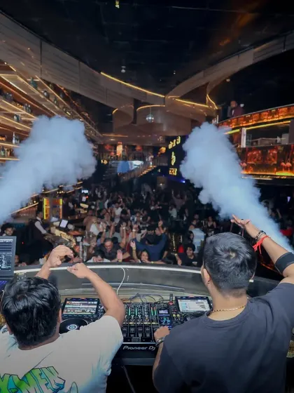 A view from behind the decks as the CO2 cannons envelop the crowd. This is about creating a complete audio-visual spectacle.