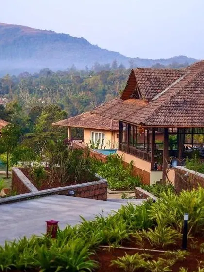 The charming, sloping-roof architecture of a resort in Sakleshpur, blending perfectly with the hilly landscape.