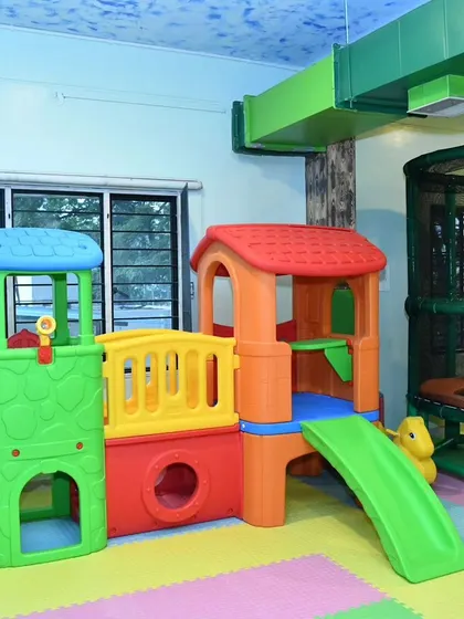 This colorful playhouse structure is perfect for toddlers and preschoolers. It features a small slide and climbing area, encouraging imaginative and active play.